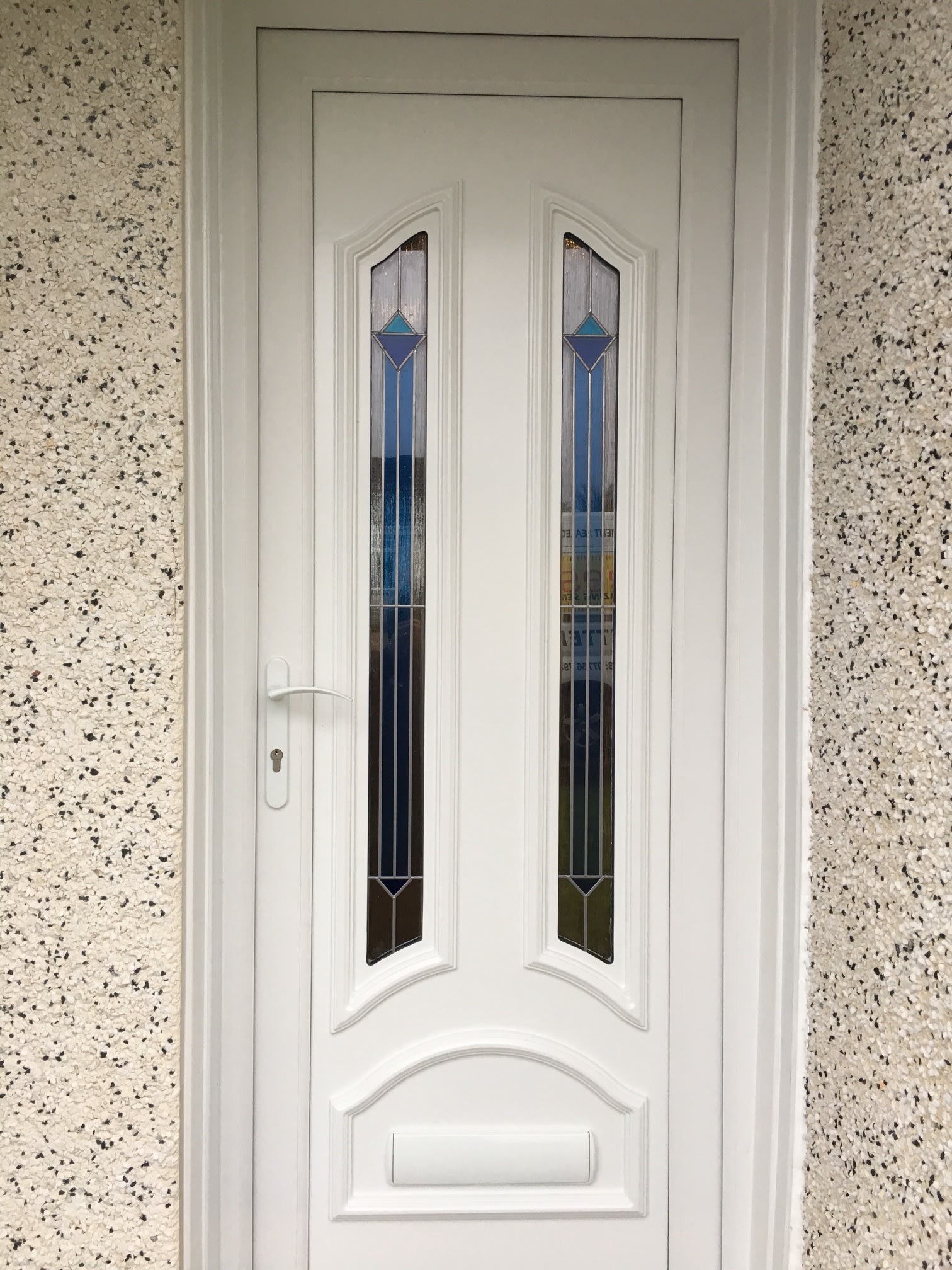 White door with decorative double glazed panels.